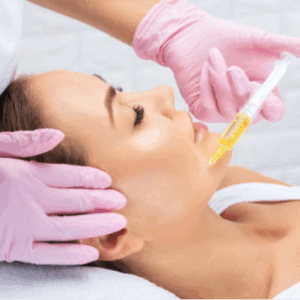 Profesional de salud aplicando tratamiento de plasma rico en plaquetas en el rostro de una paciente en una clínica estética.